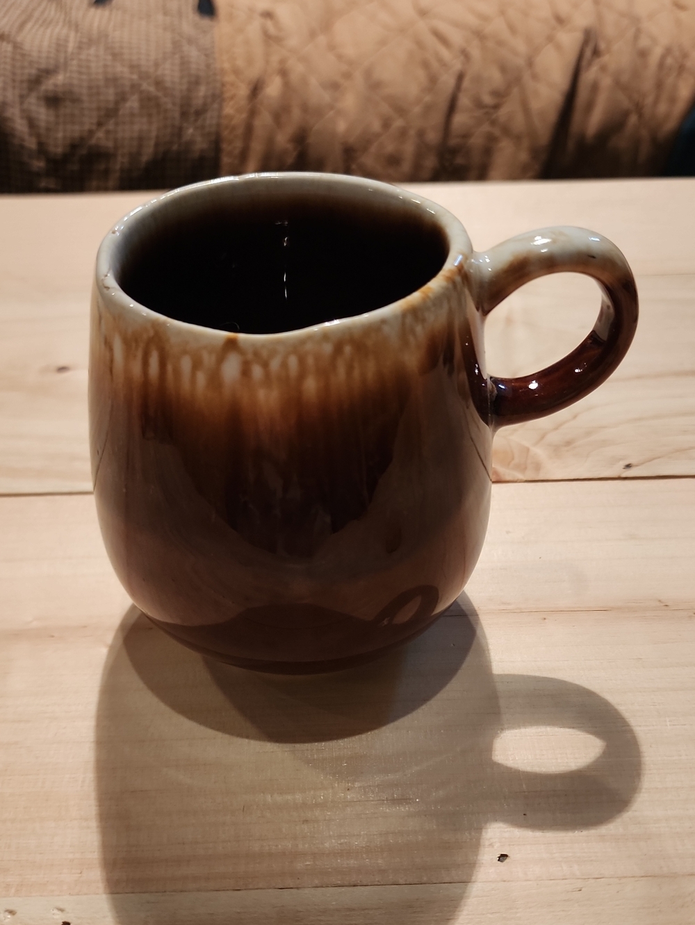McCoy Pottery piece featuring a classic brown drip glaze model number 7025
